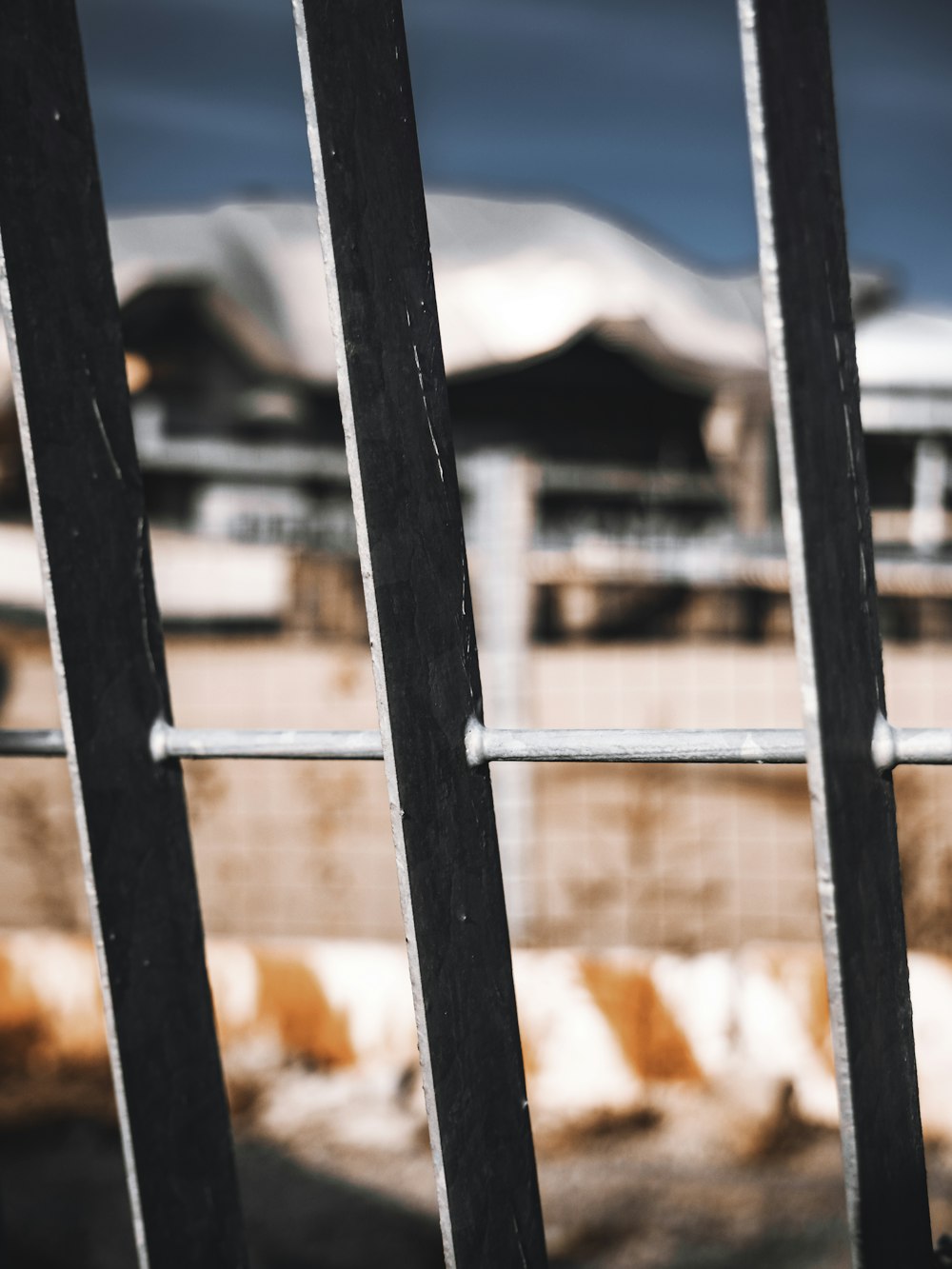 black wooden fence near mountain under blue sky during daytime