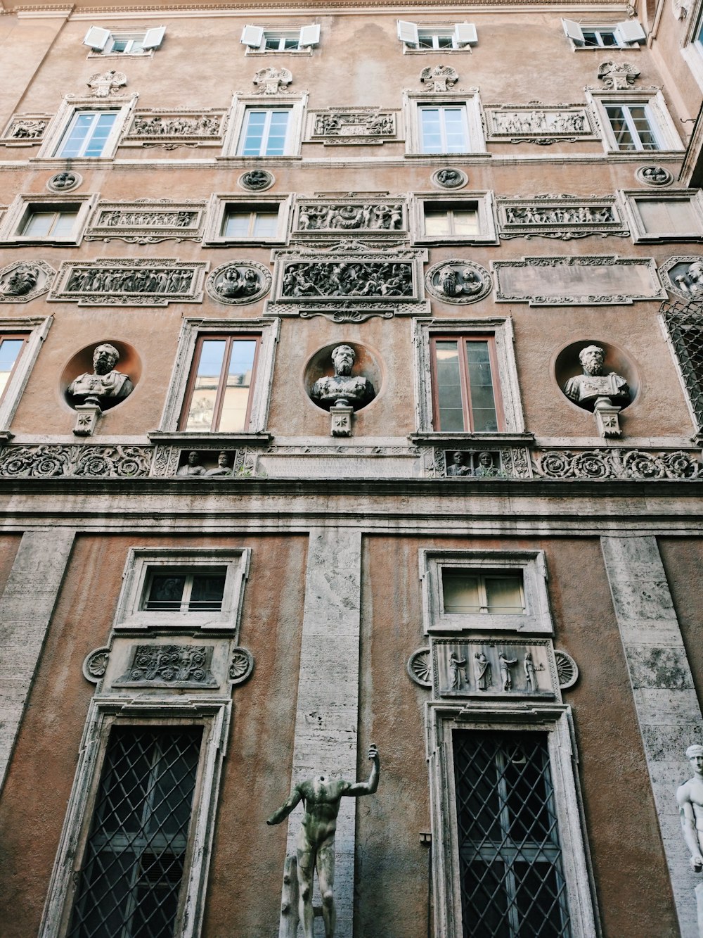 brown concrete building with black metal window