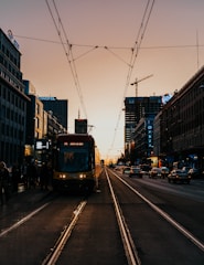 red and white tram on road during night time