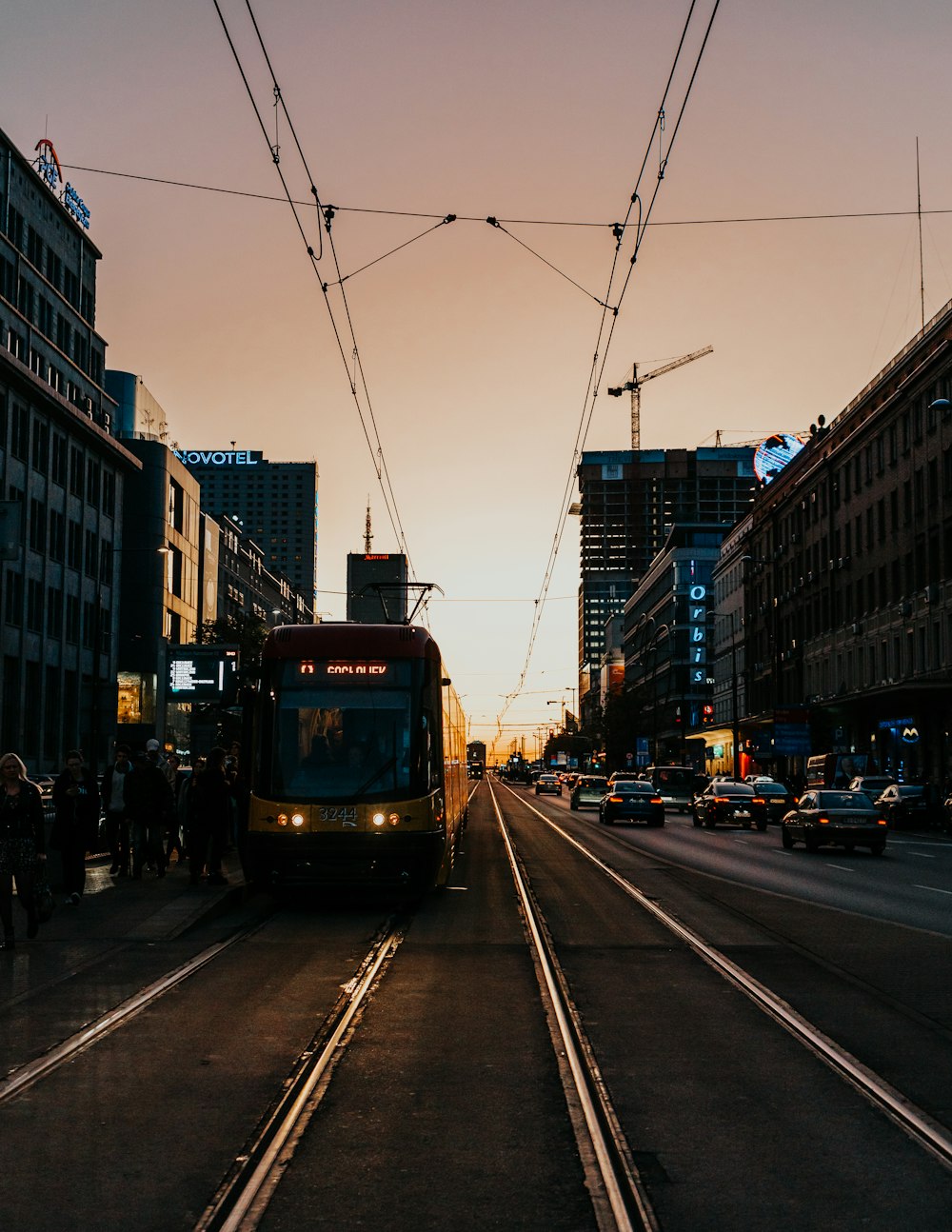 red and white tram on road during night time