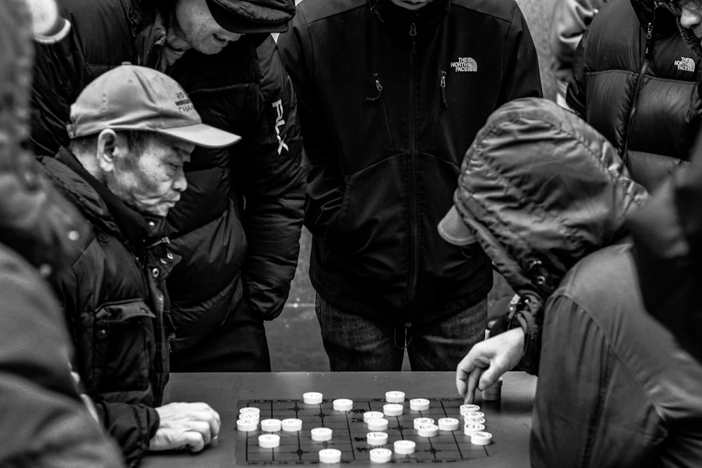 man in black jacket playing chess