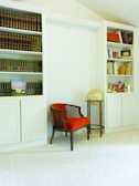 A cozy reading nook with a comfortable chair and bookshelves.
