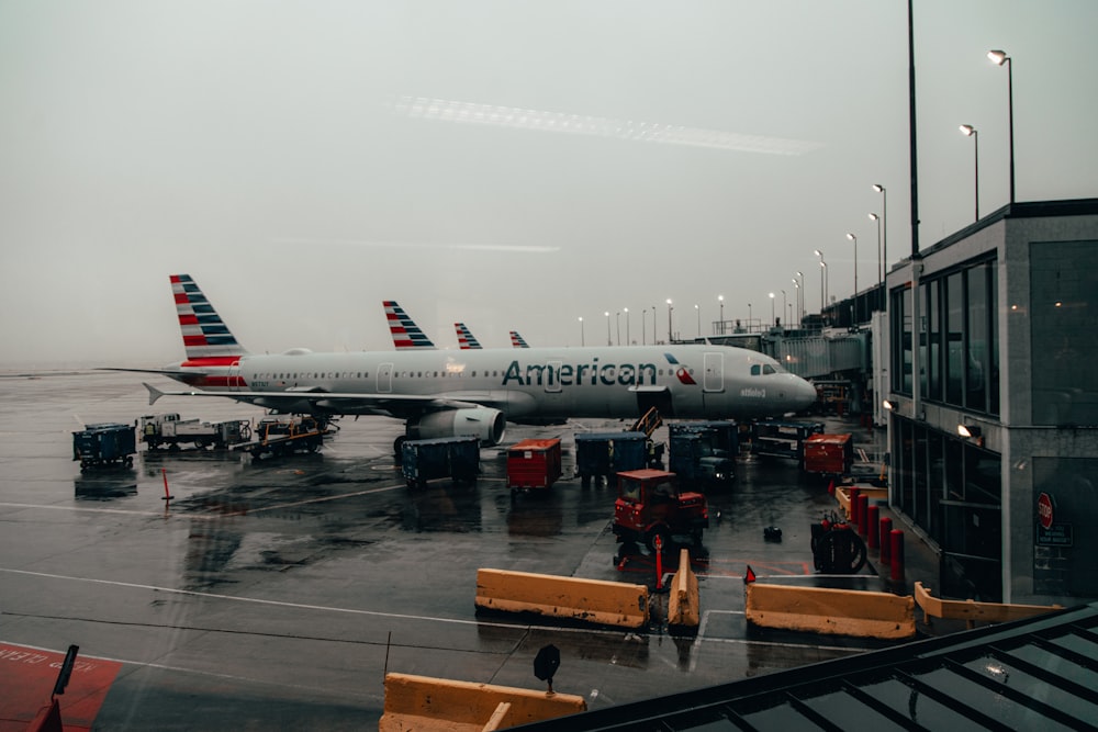 people standing near white and red airplane during daytime