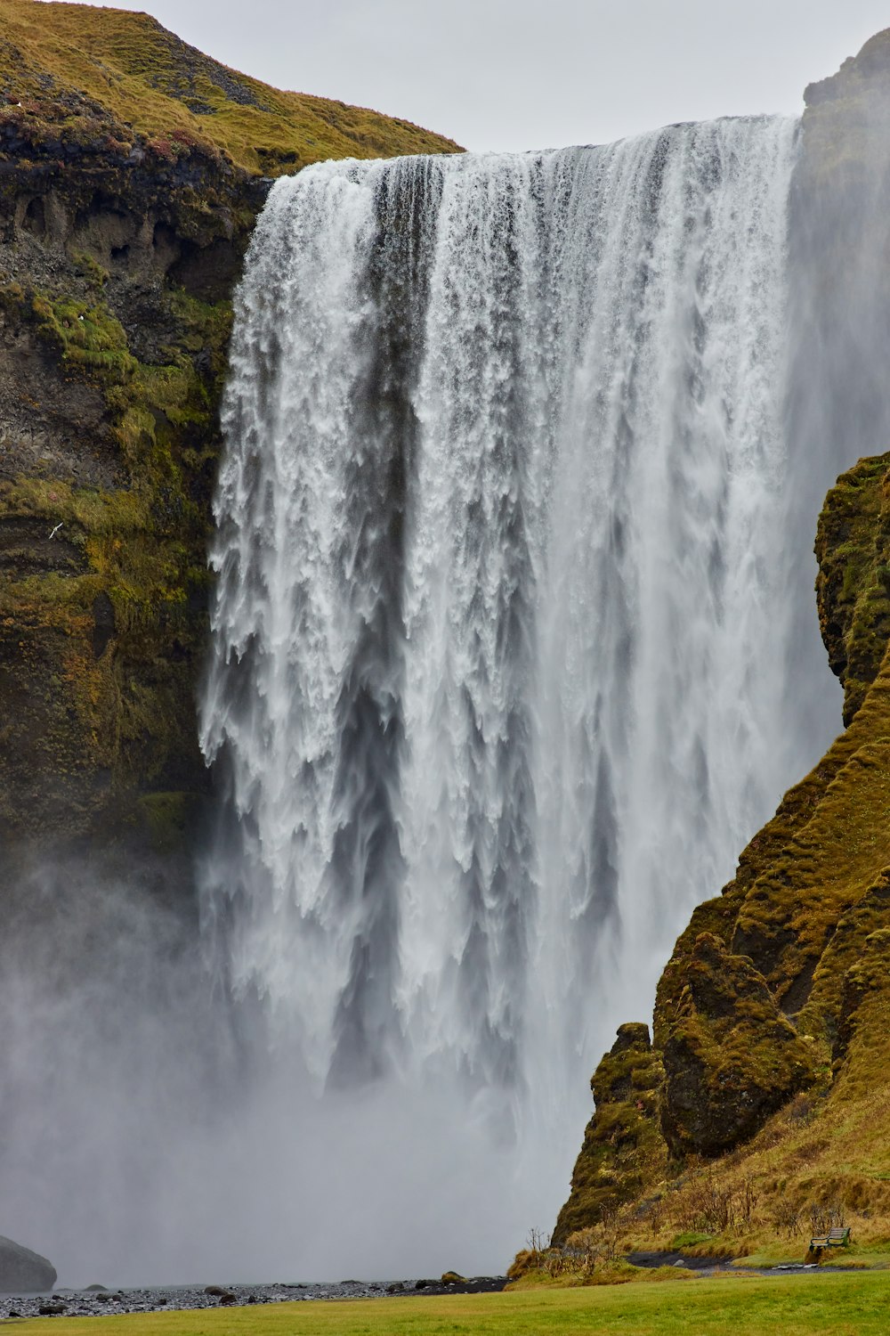 waterfalls on brown rocky mountain during daytime