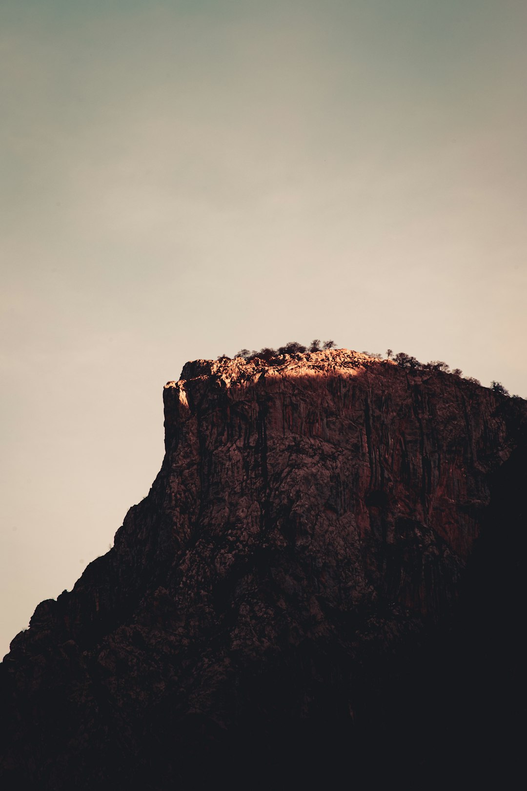 brown rocky mountain under white sky during daytime