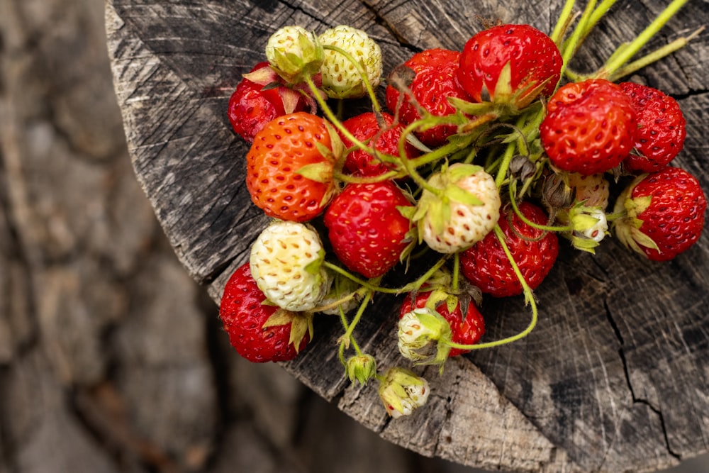 red strawberries on brown wooden table