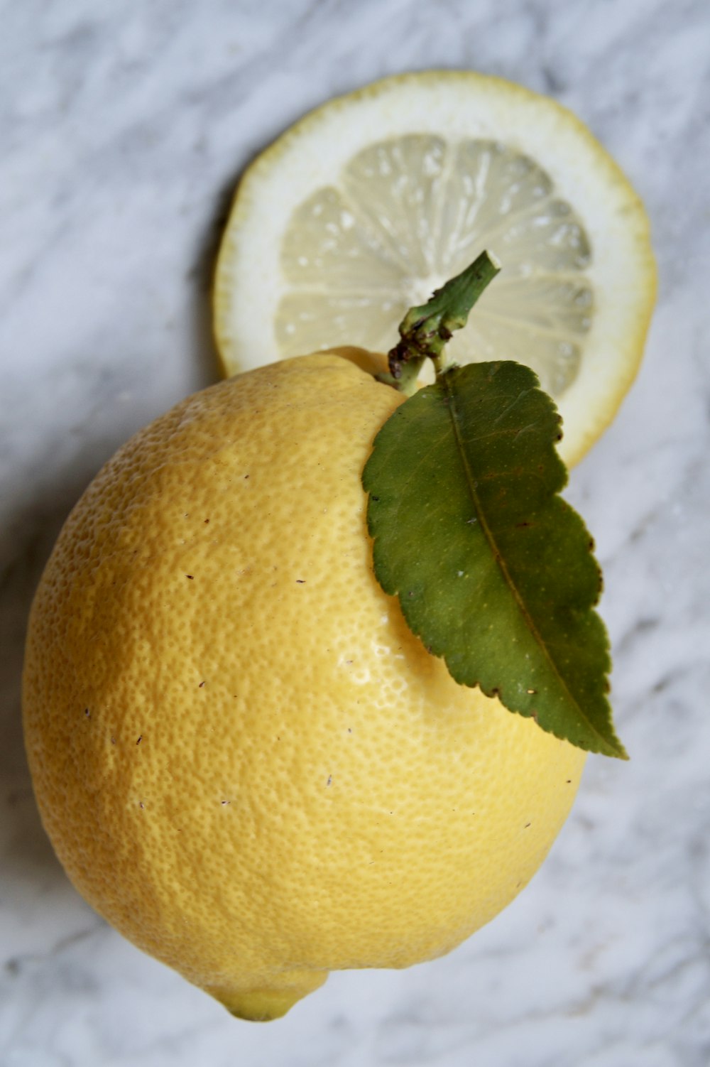 yellow lemon fruit on white textile