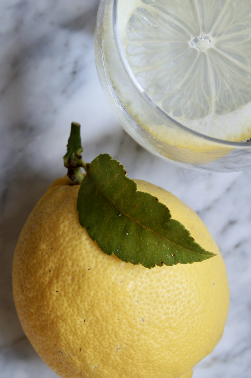 yellow lemon fruit on clear glass container