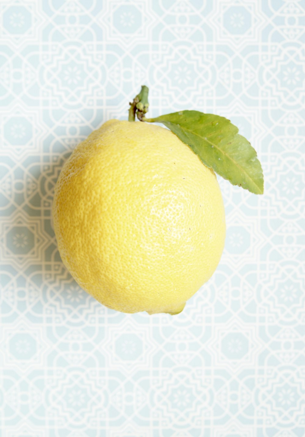 Fruta de limón amarillo sobre textil blanco y azul