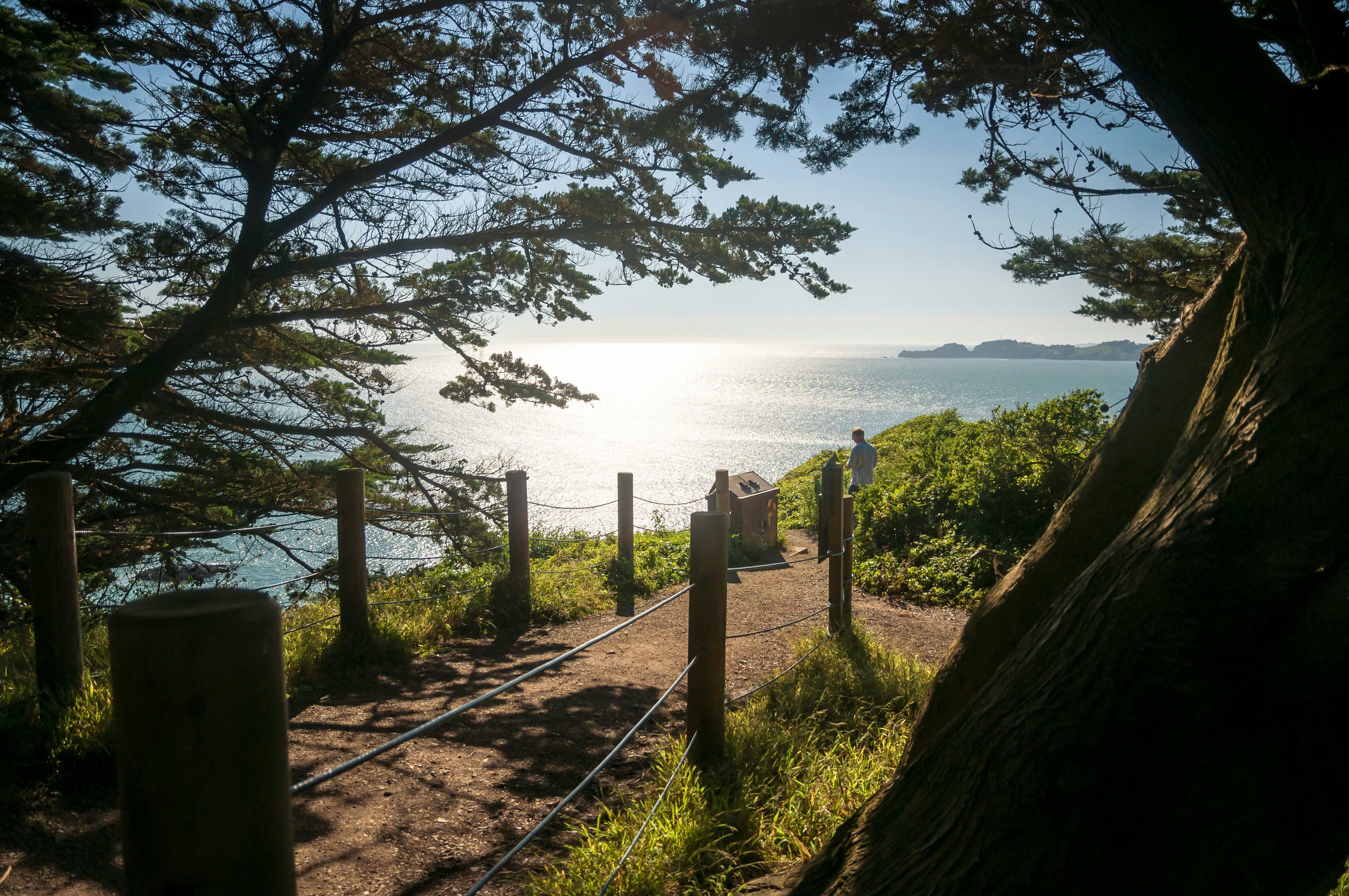 brown wooden fence near body of water during daytime