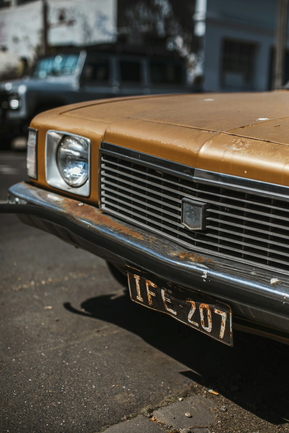 orange car on gray asphalt road during daytime