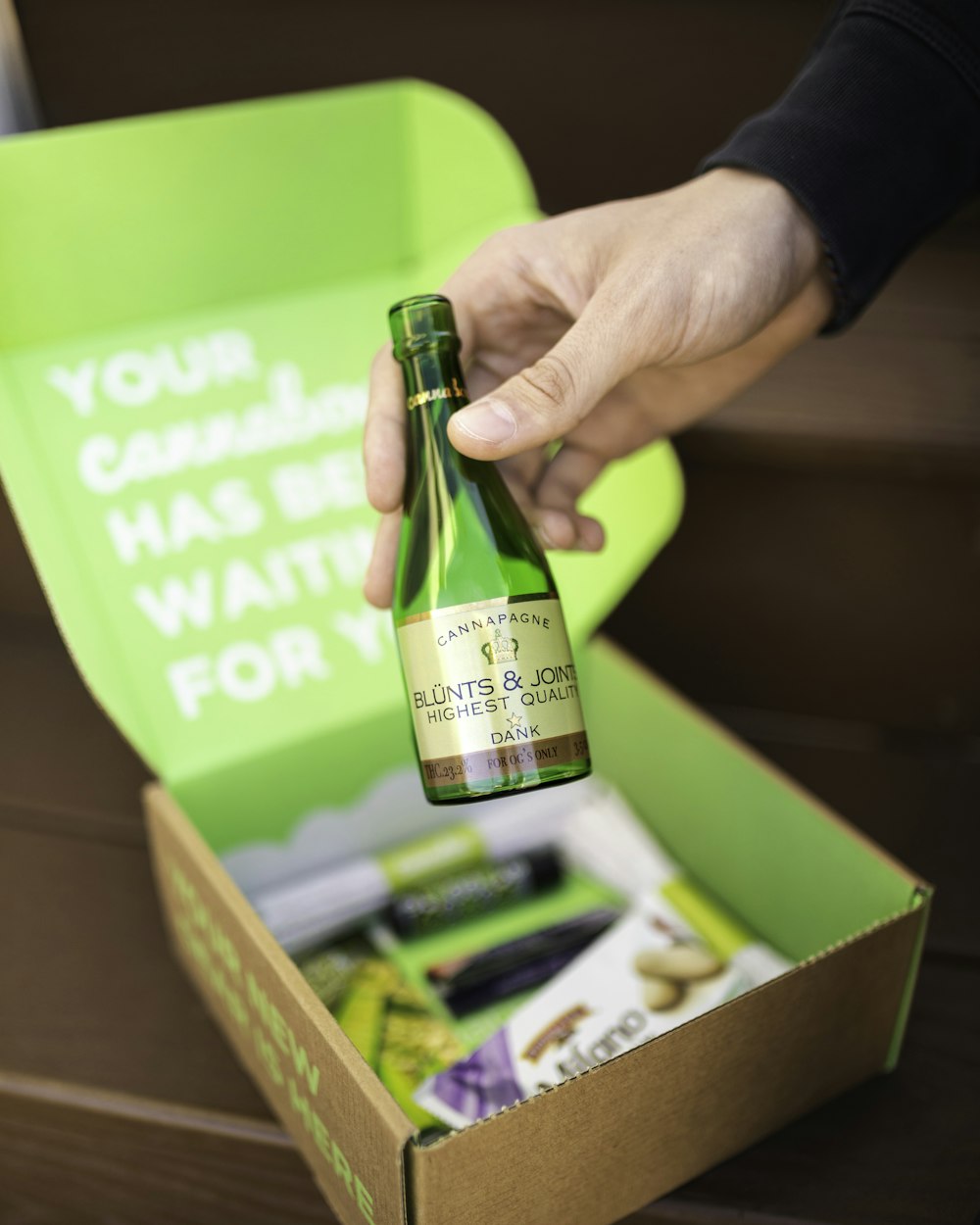 person holding green and white labeled bottle