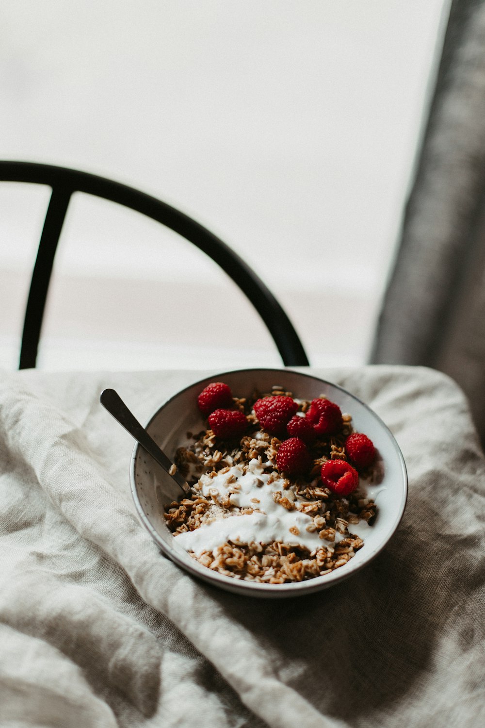 white and red berries on white ceramic bowl