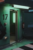 green metal door with number 2