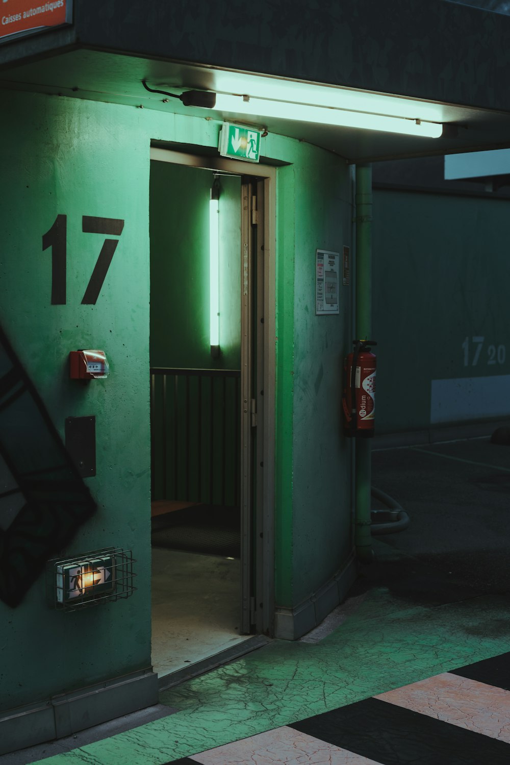 green metal door with number 2