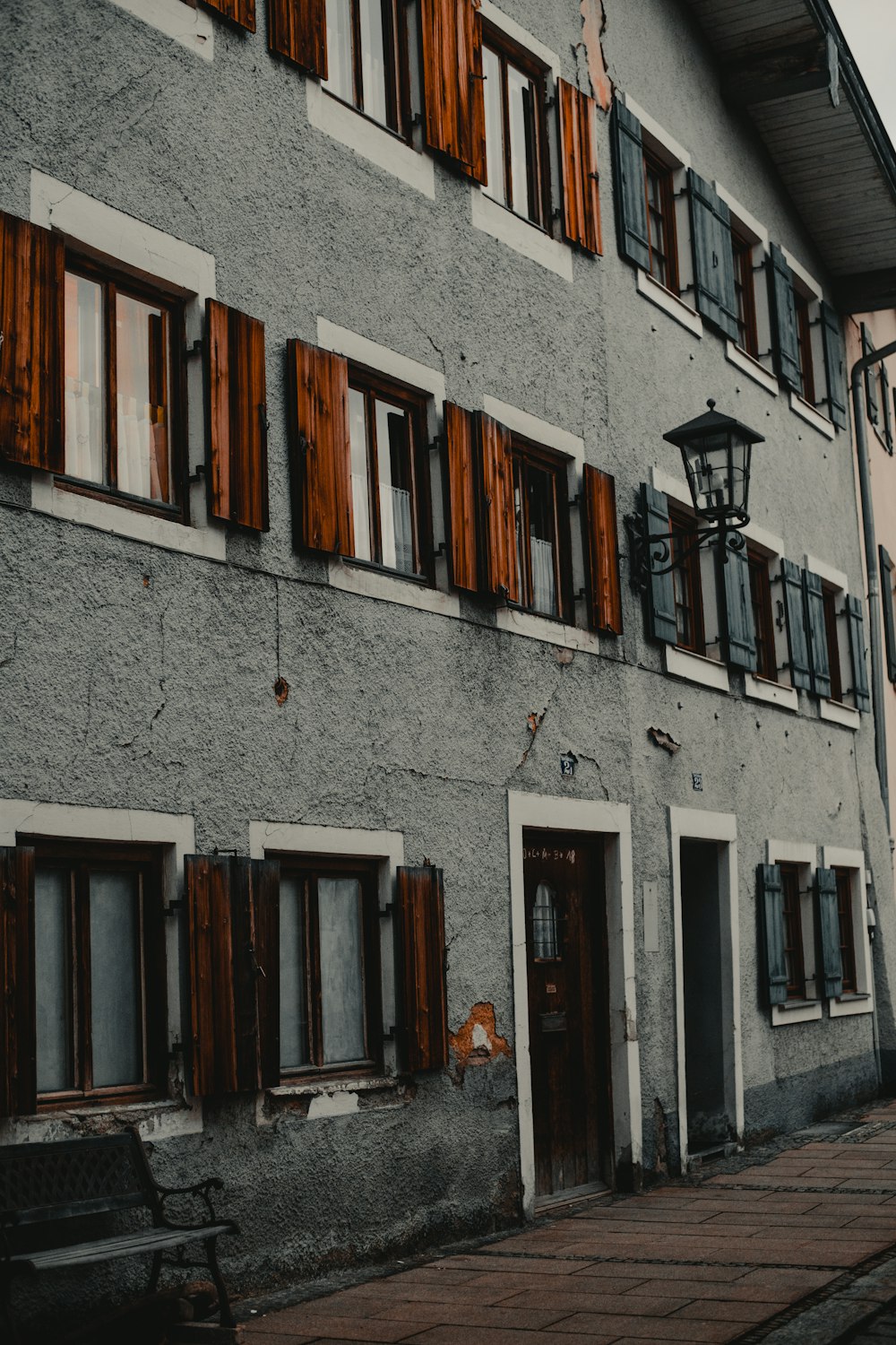 gray concrete building with brown wooden windows