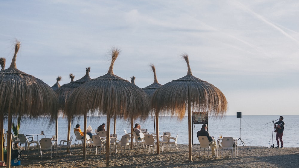 group of people standing on beach during daytime