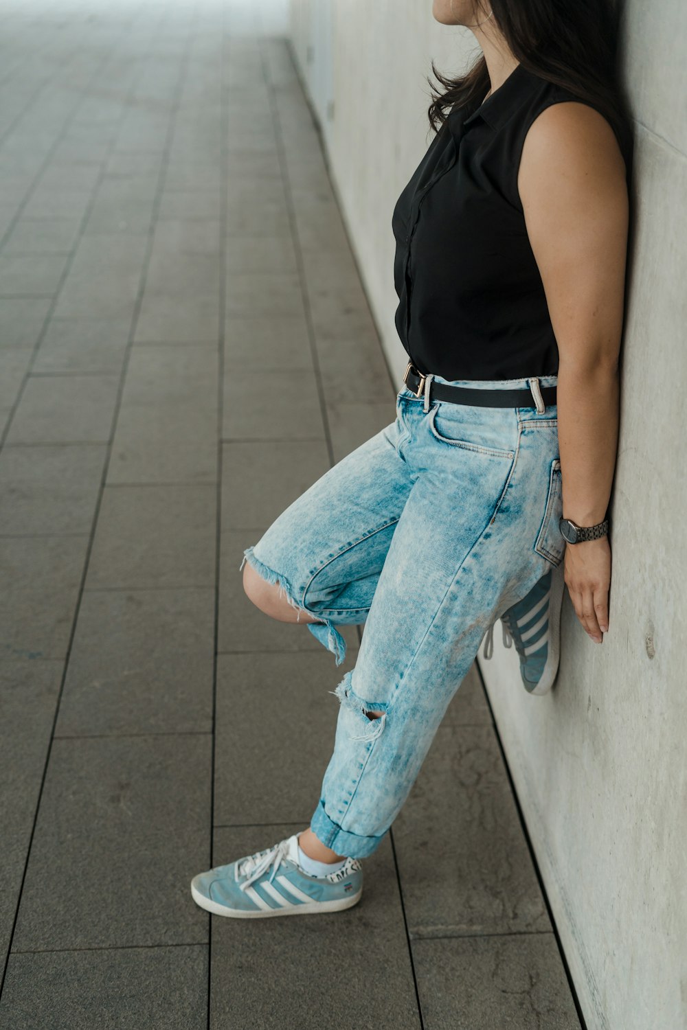 woman in blue denim jeans and black tank top