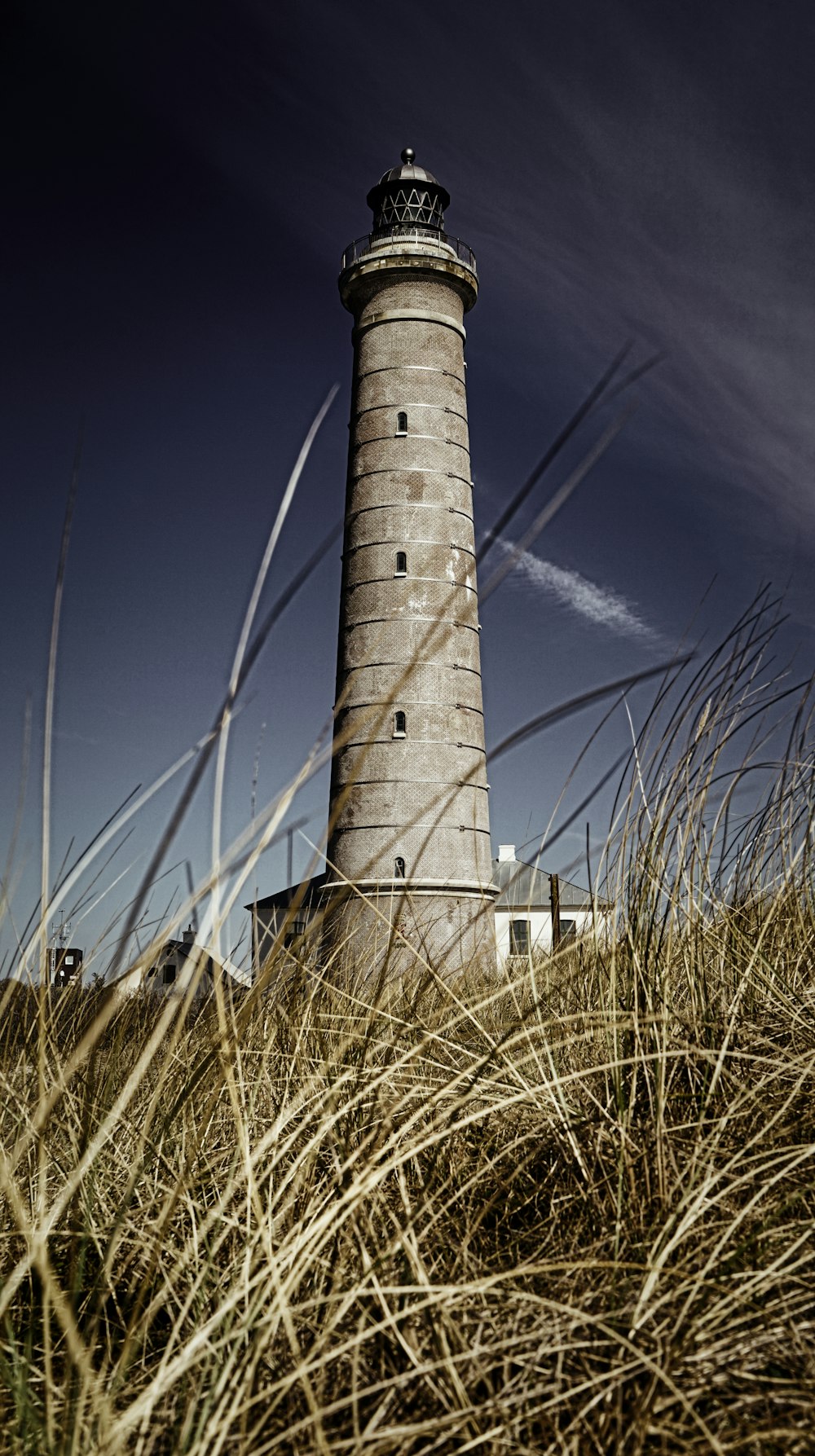 white and black lighthouse under blue sky during daytime