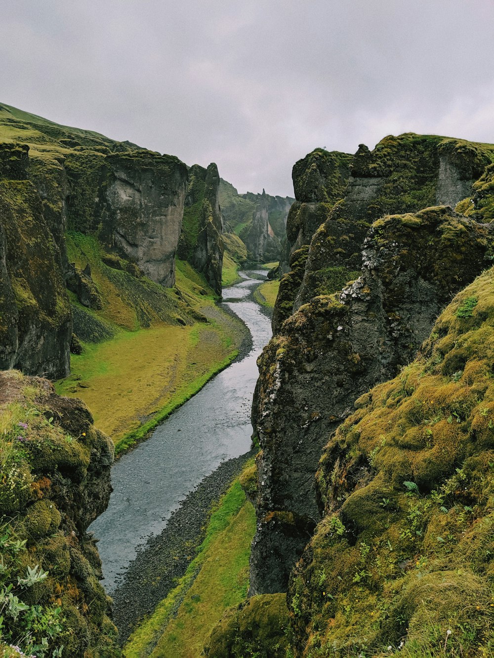 green grass field beside river