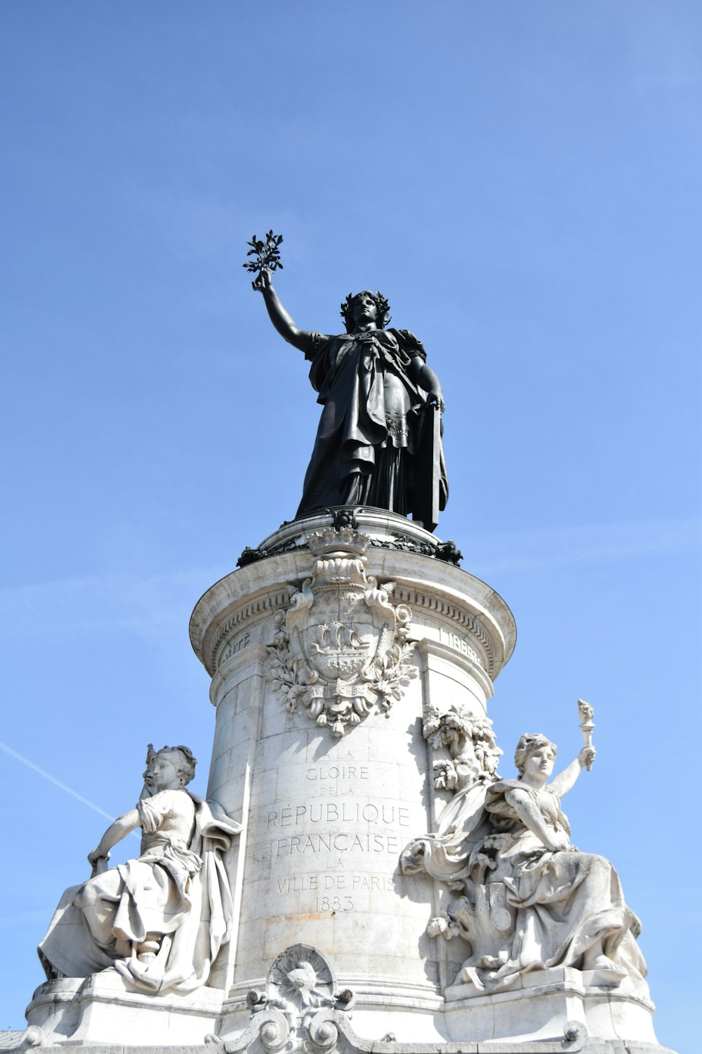 people riding horses statue under blue sky during daytime