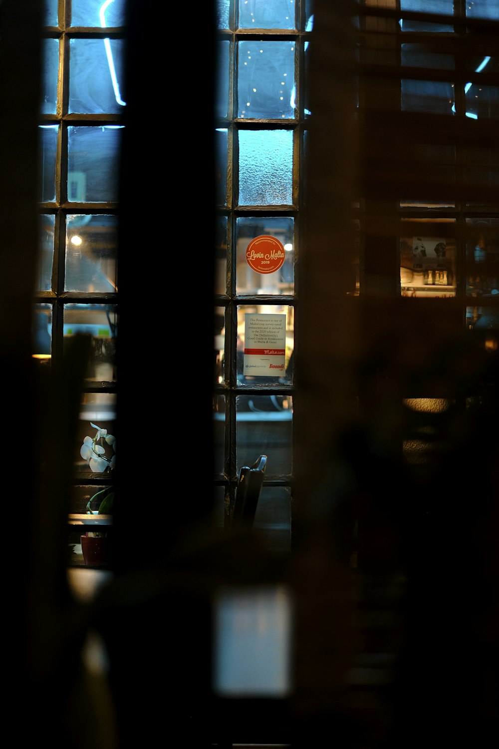 silhouette of person sitting on chair near window