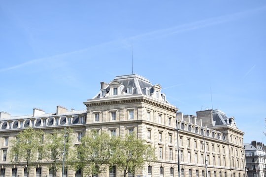 beige concrete building under blue sky during daytime in Place de la République France