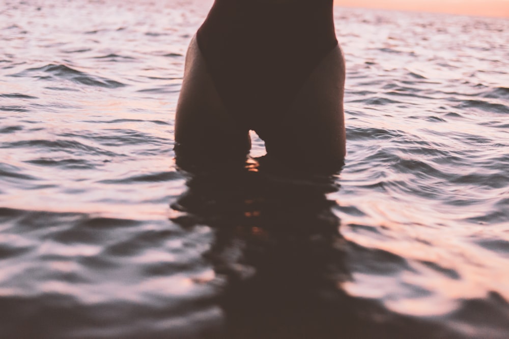 woman in black bikini bottom on water