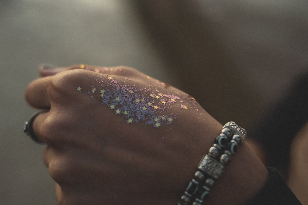 silver and diamond ring on persons finger