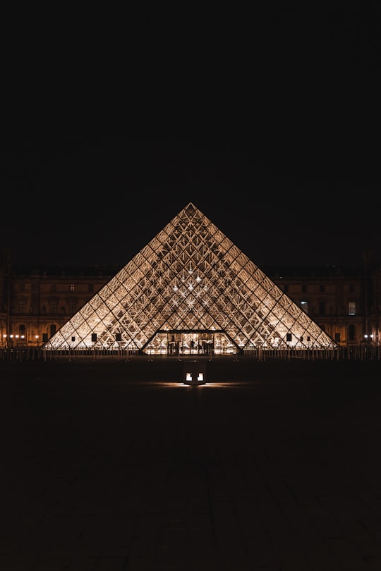 black and white pyramid building during night time in Louvre France