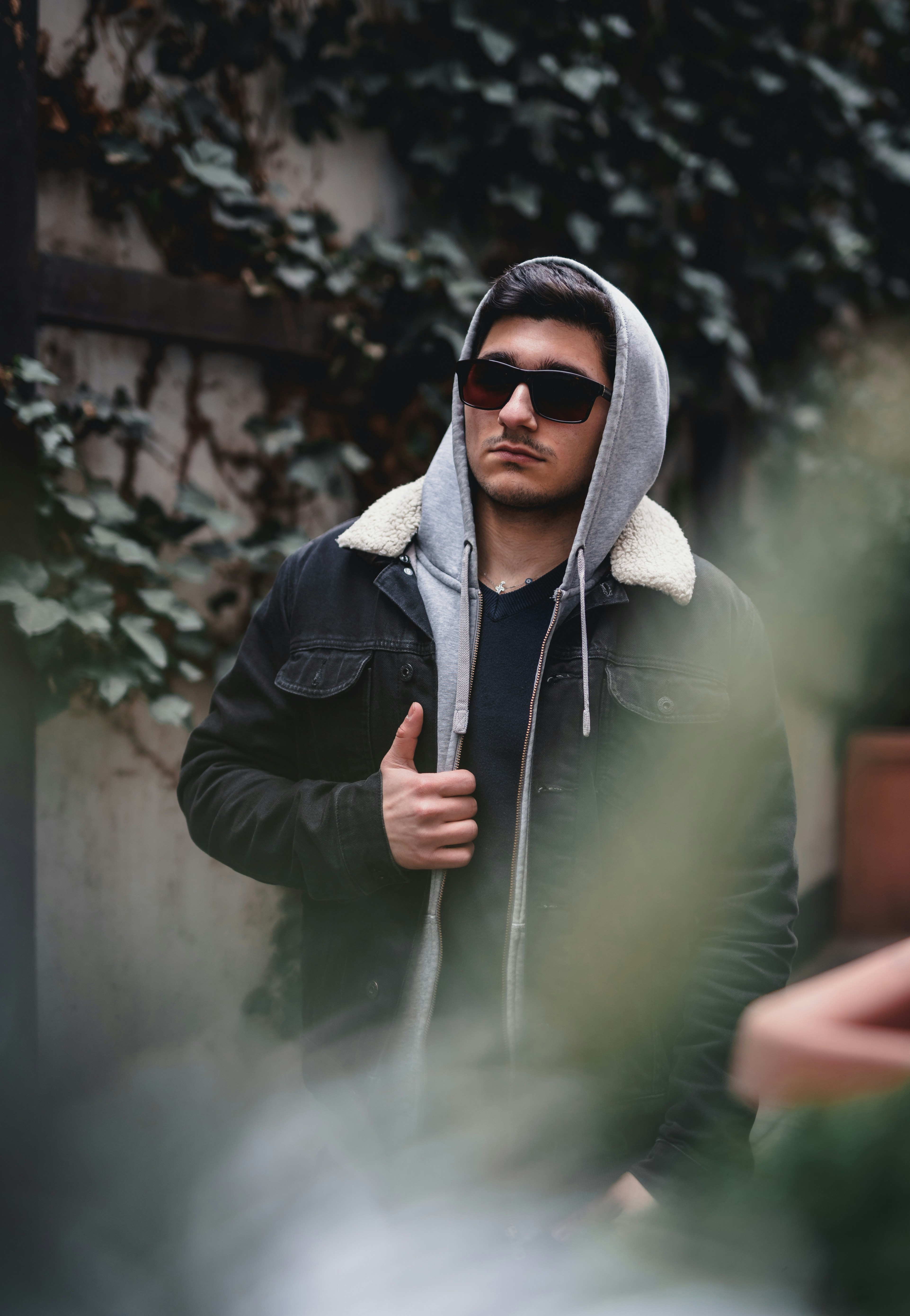man in black jacket wearing black sunglasses
