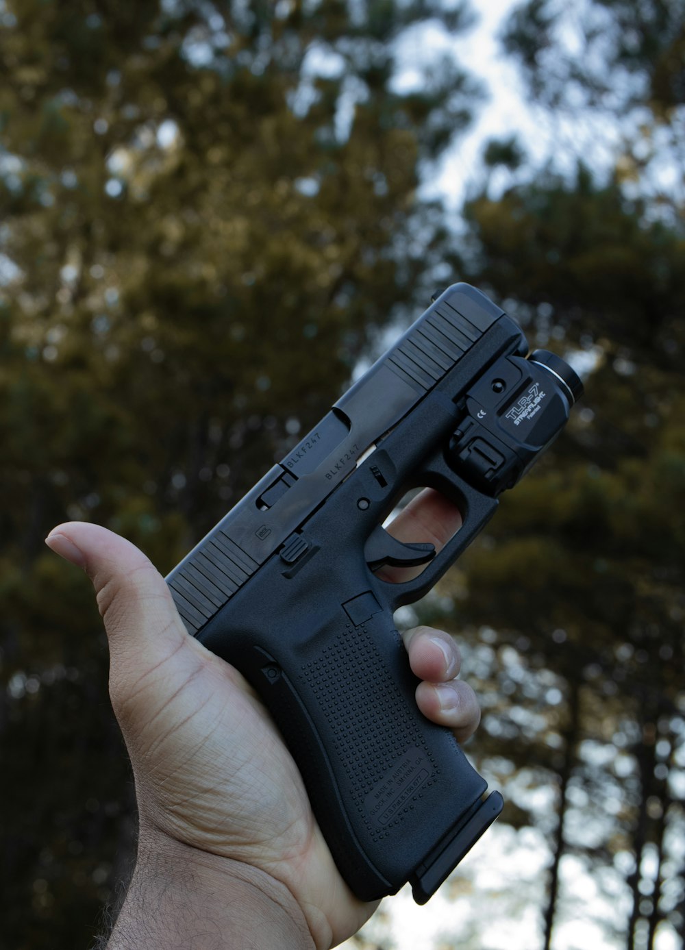 person holding black semi automatic pistol