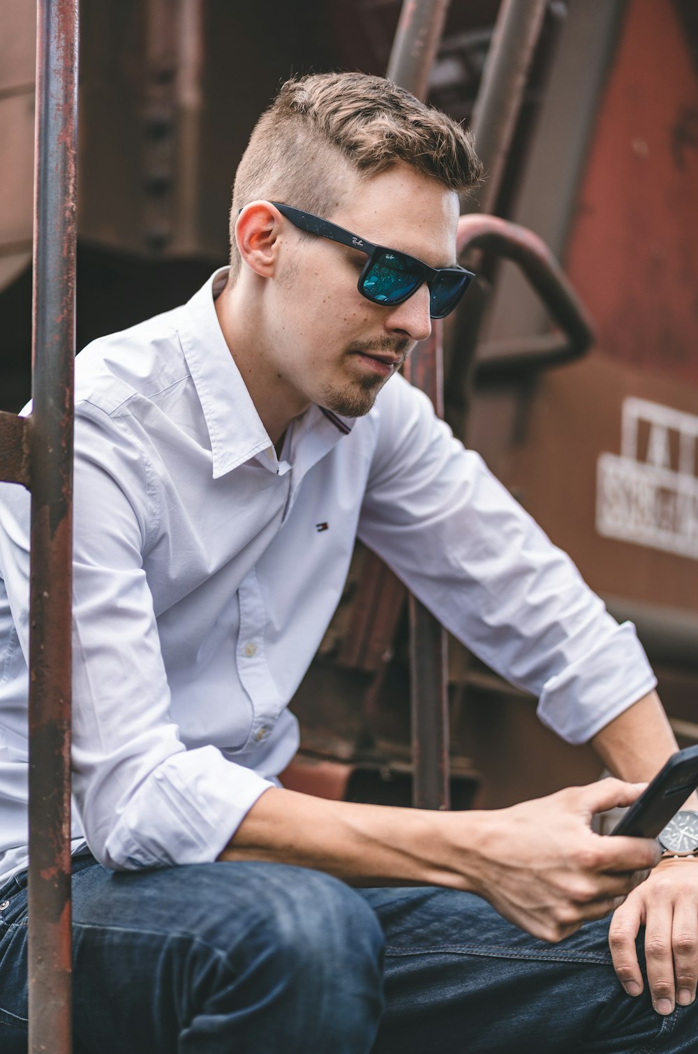 man in white dress shirt wearing blue sunglasses