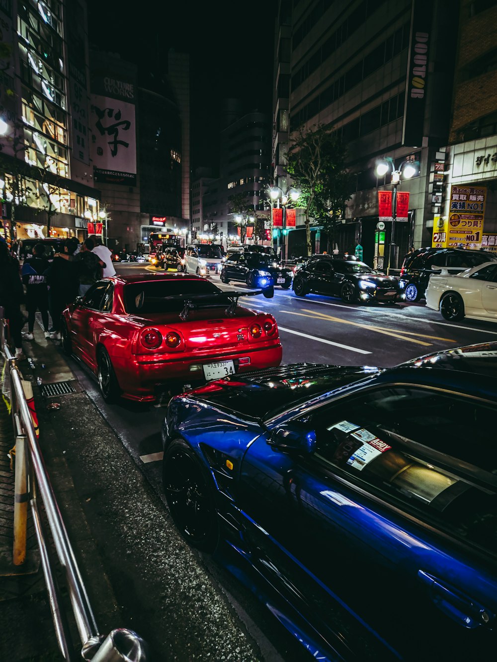 red car on the street during daytime