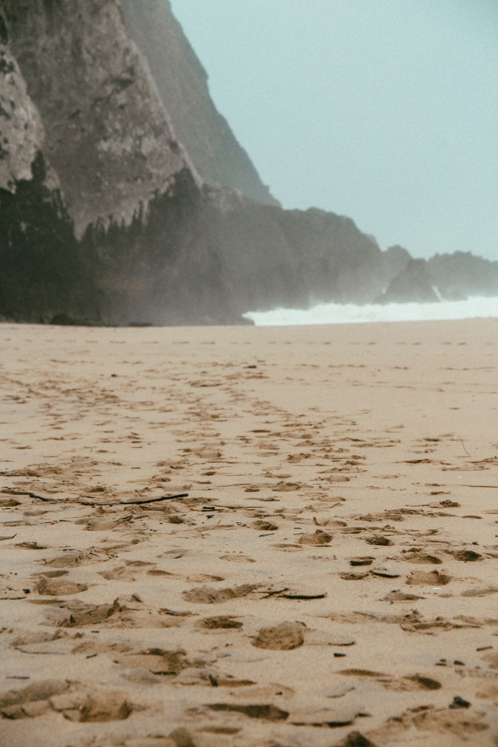 brown sand near body of water during daytime