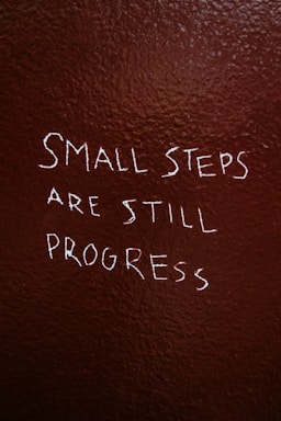 Small steps are still progress written on brown background