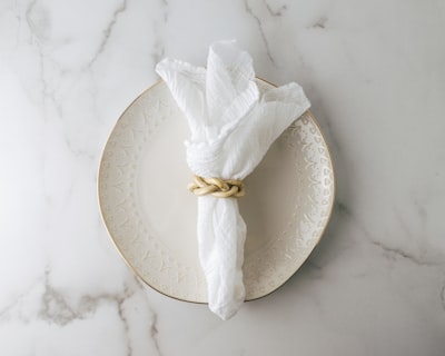 white tissue paper on white round plate napkin zoom background