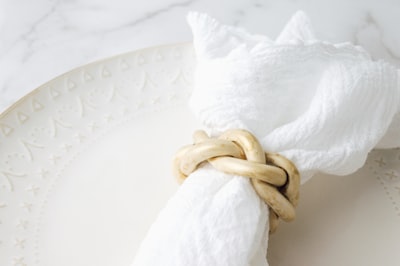 white textile with brown rope napkin teams background