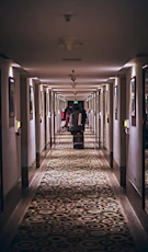 person in black jacket walking on hallway