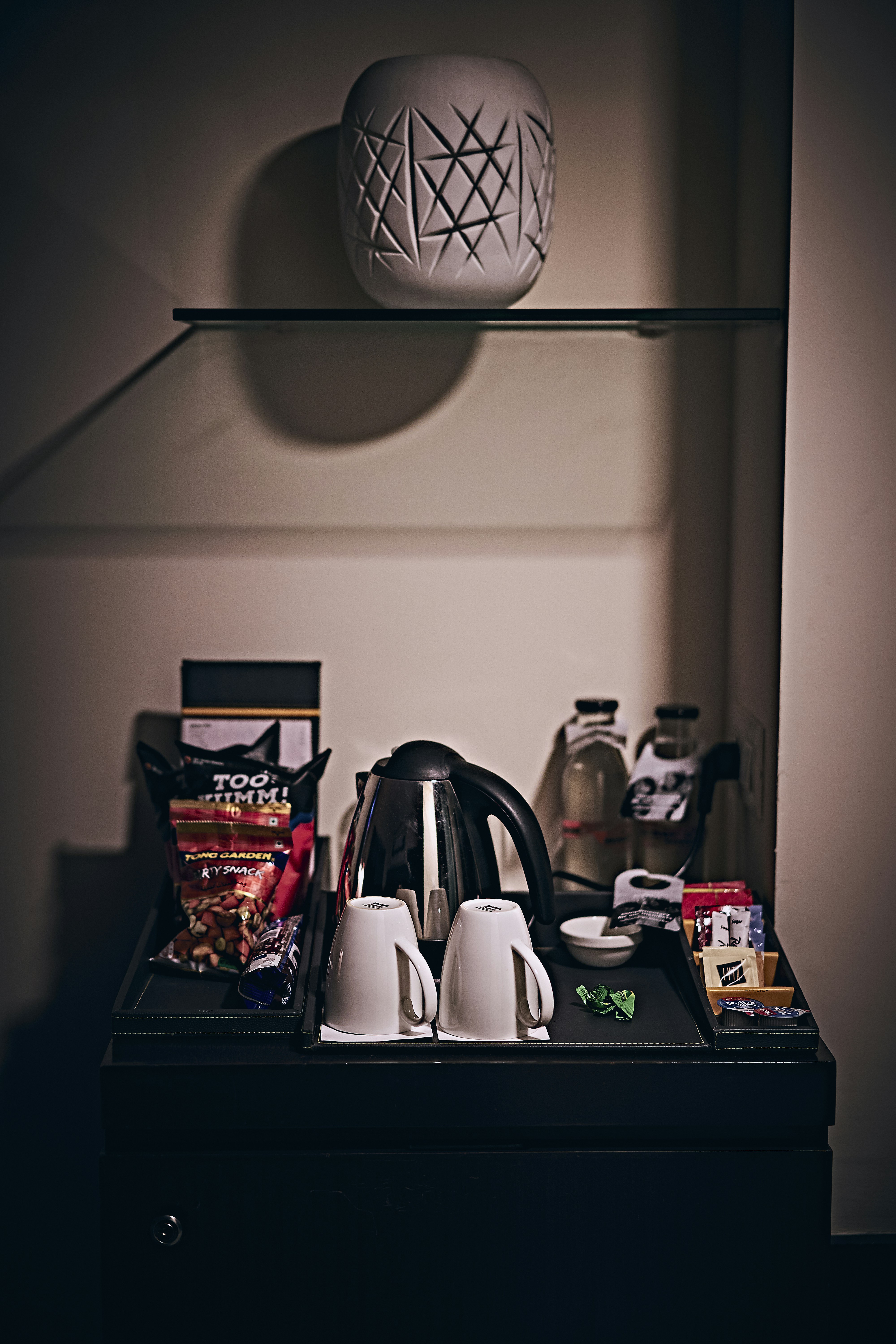 black and white ceramic teapot on black wooden table