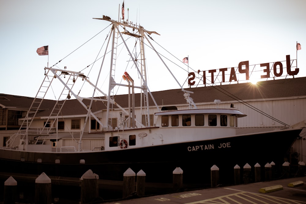 white and black ship on dock during daytime