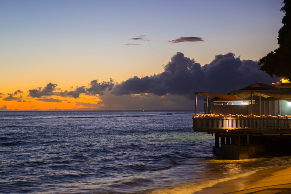 brown wooden dock on sea during sunset