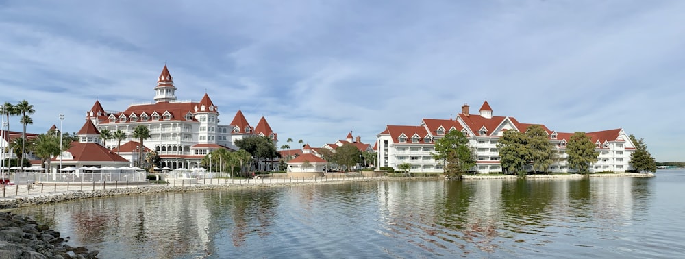 white and brown concrete houses near body of water during daytime