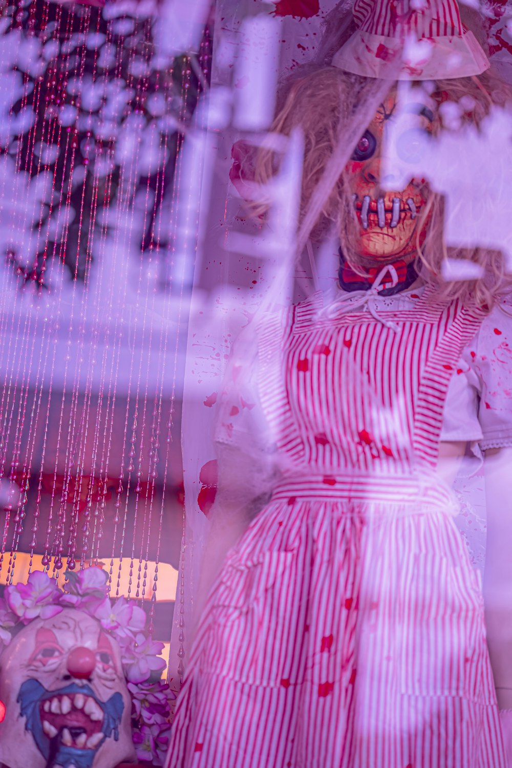 woman in pink dress standing beside window