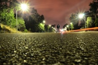 Nighttime shot of a Lumina Apparel windbreaker catching the glow of streetlights during an evening stroll.