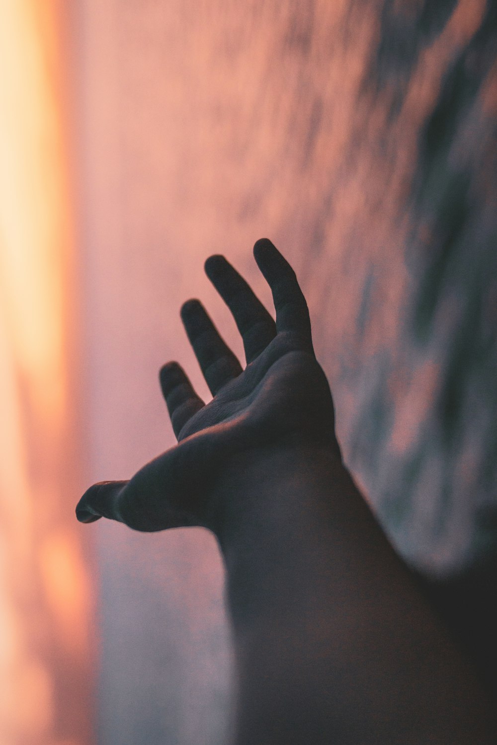 persons left hand on brown textile