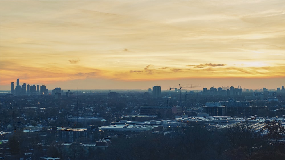 city skyline under cloudy sky during sunset