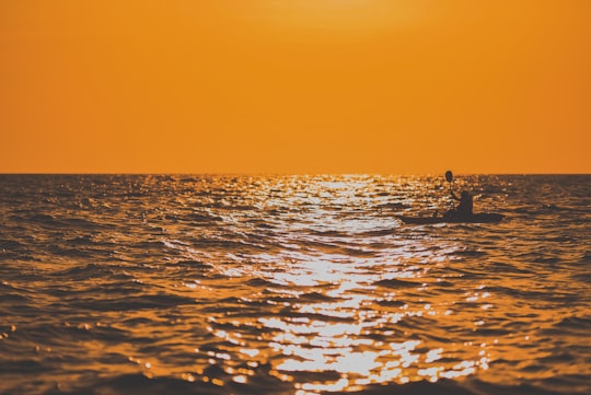 silhouette of people on boat during sunset in Chonburi Thailand