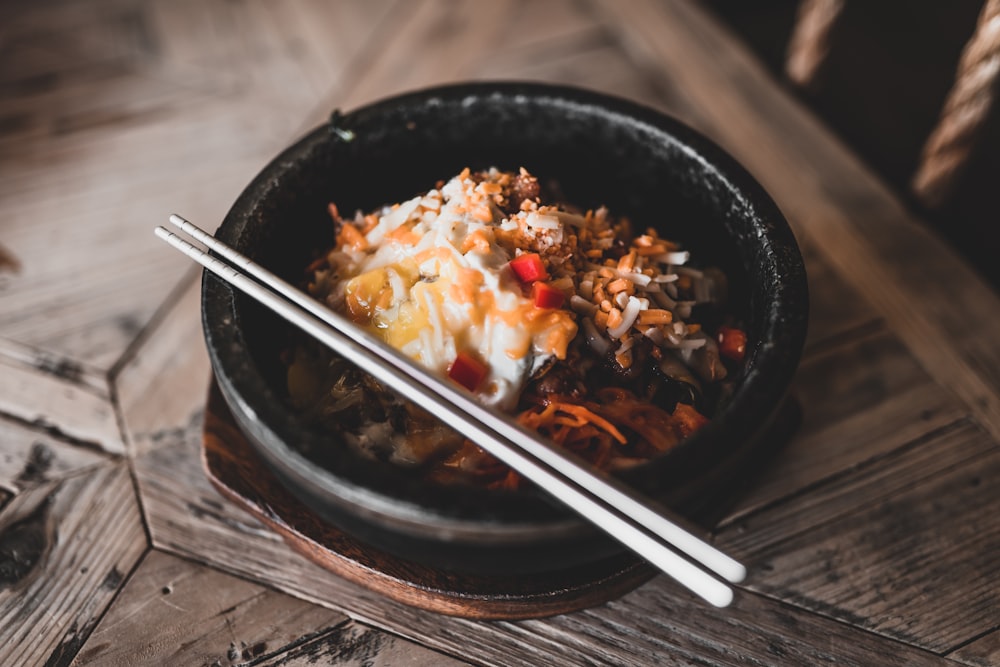 black ceramic bowl with chopsticks