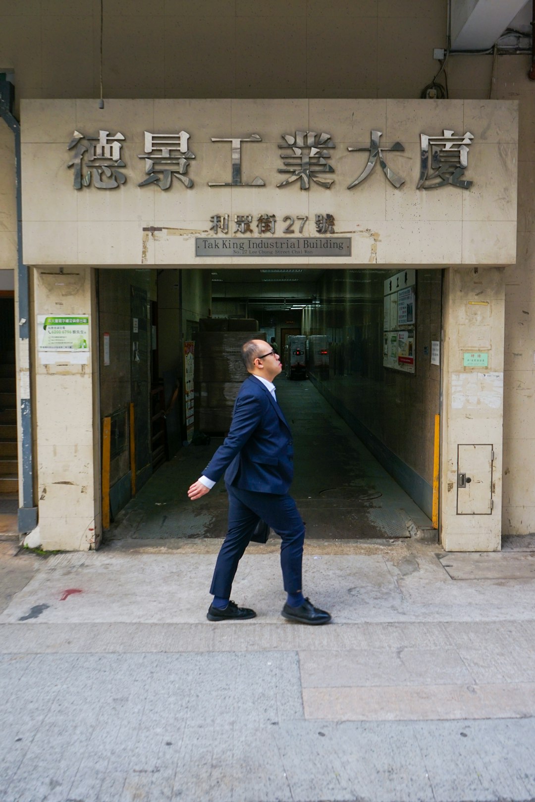 man in blue suit jacket and blue denim jeans walking on sidewalk during daytime